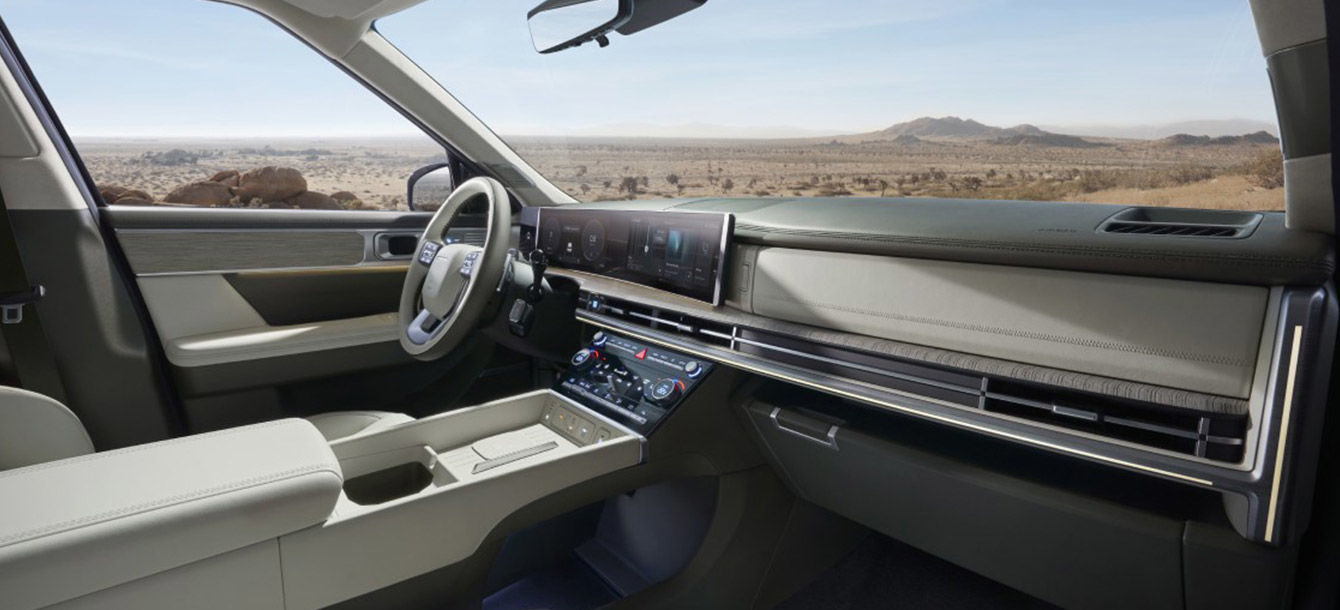 Side-front view of orange Grandi10 with lakeside view at night