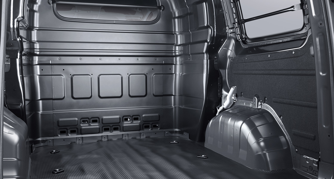 Side-front view of orange Grandi10 with lakeside view at night